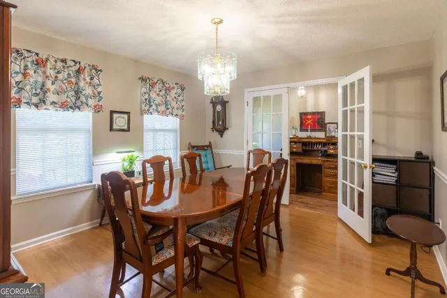 a kitchen with stainless steel appliances granite countertop a refrigerator a stove top oven a sink dishwasher and wooden cabinets