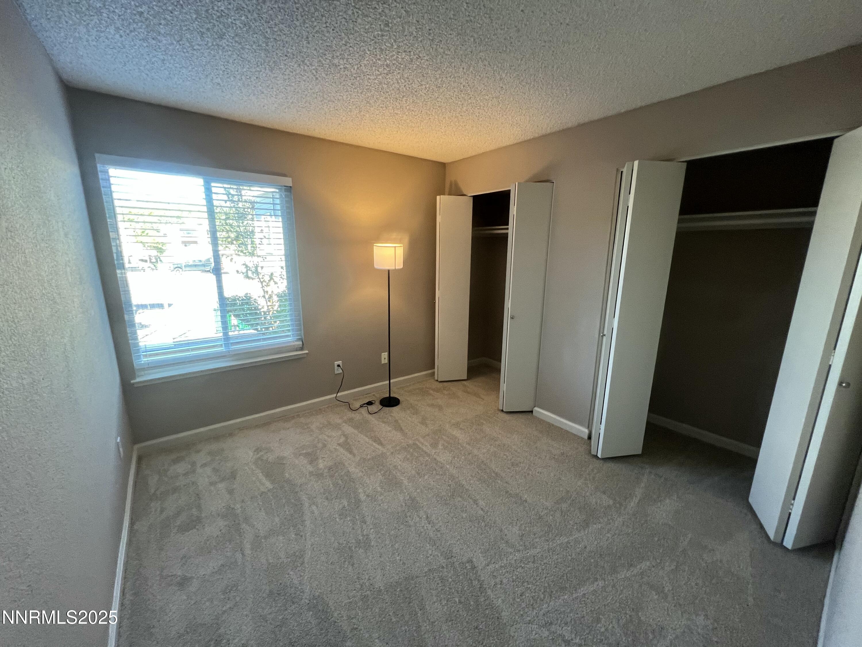 3095 Lakeside Drive, Unit 110 Reno, NV 89509 - Photo 16 of 49 a view of an empty room with window and closet area