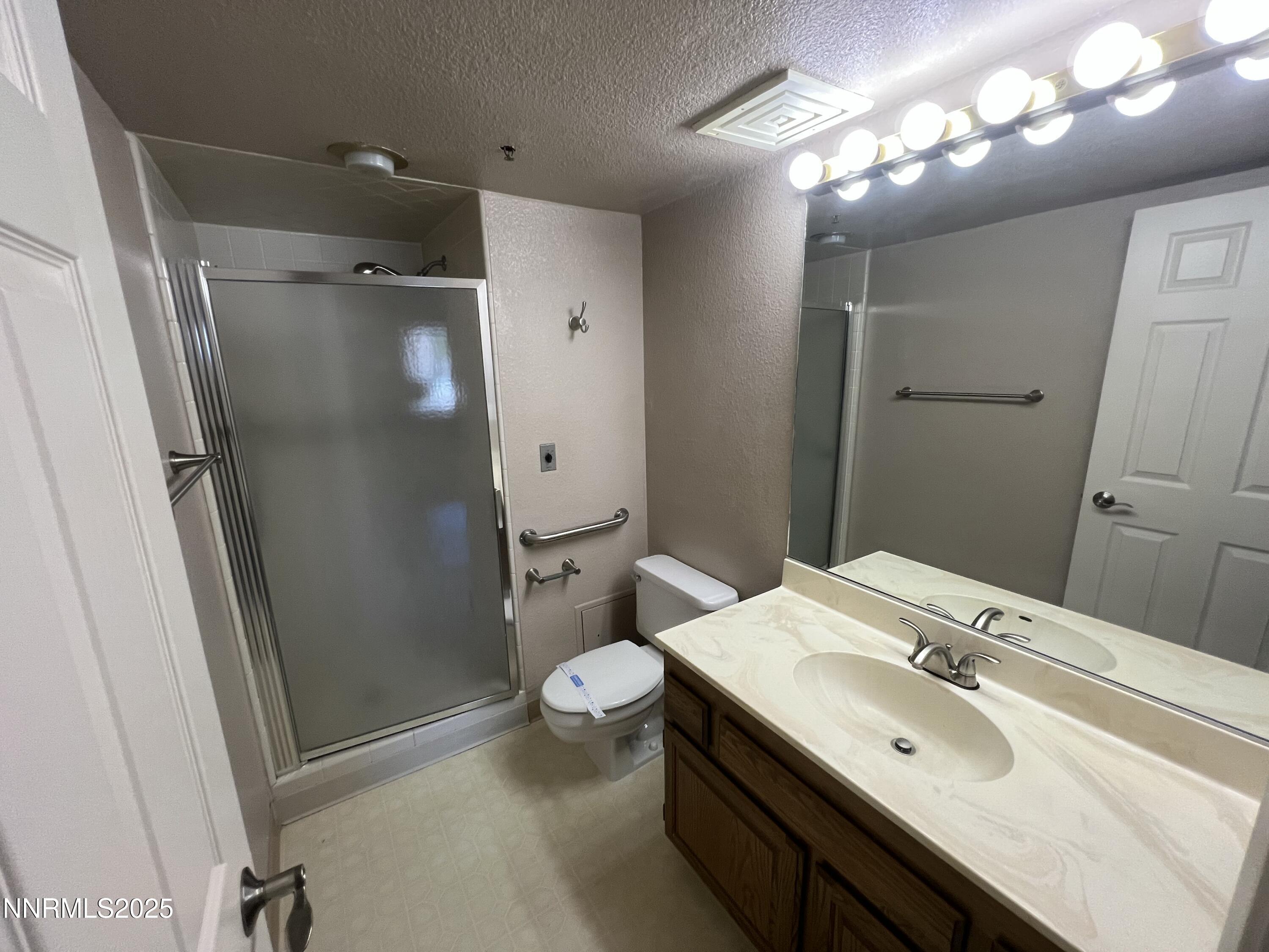 3095 Lakeside Drive, Unit 110 Reno, NV 89509 - Photo 23 of 49 a bathroom with a sink toilet and shower