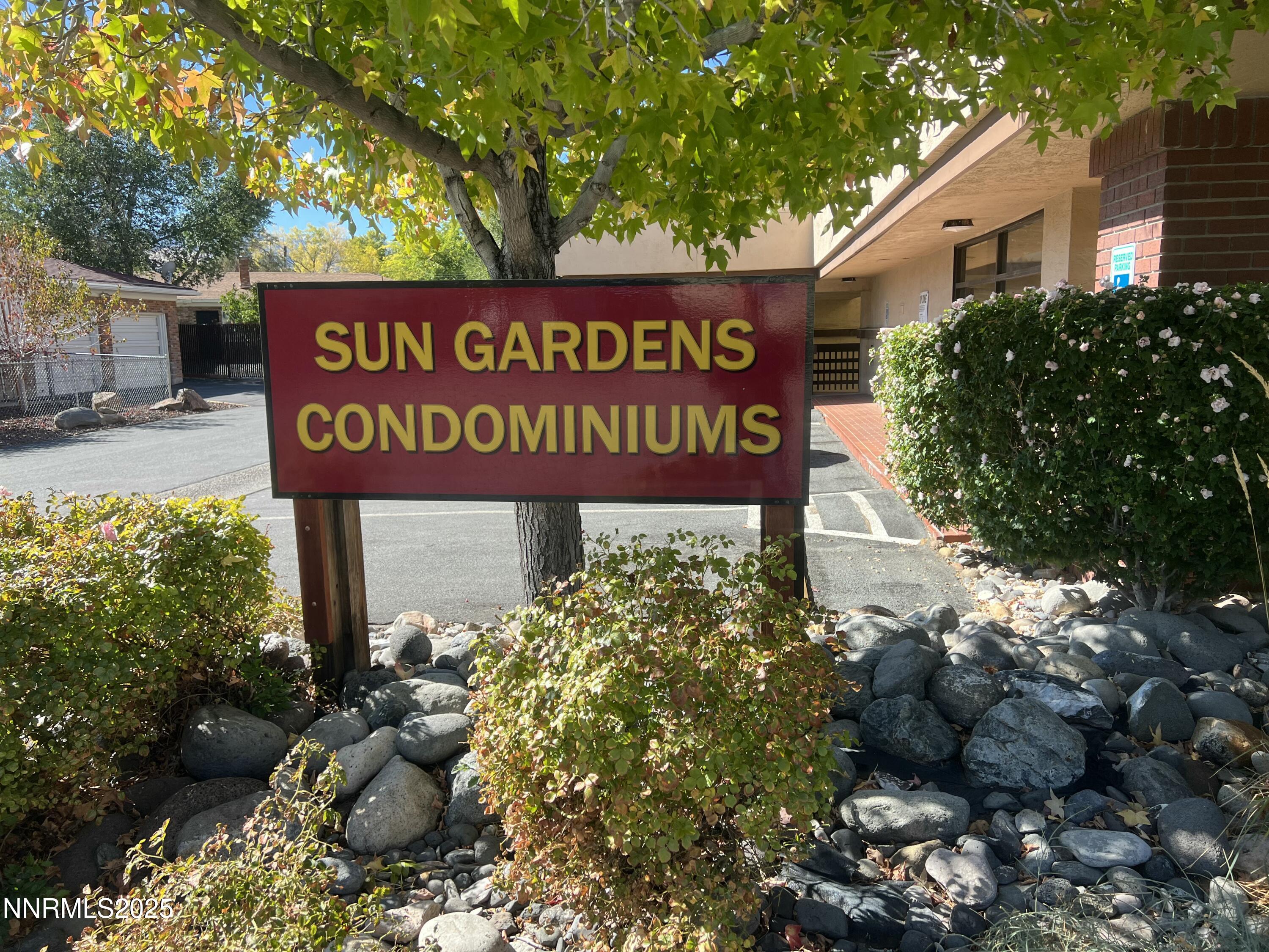3095 Lakeside Drive, Unit 110 Reno, NV 89509 - Photo 3 of 49 a sign broad in front of flowers