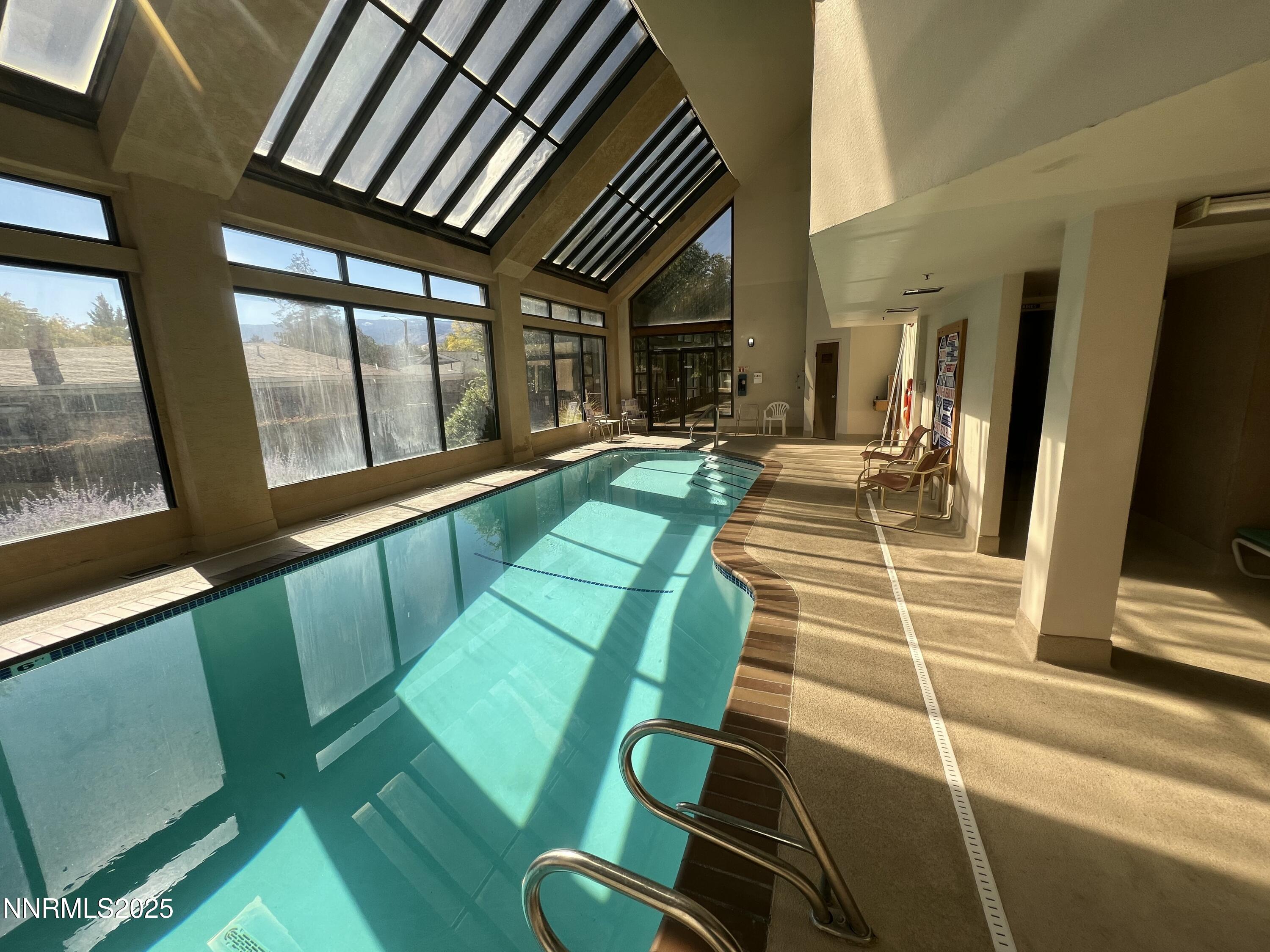 3095 Lakeside Drive, Unit 110 Reno, NV 89509 - Photo 44 of 49 a living room with chairs and a large window