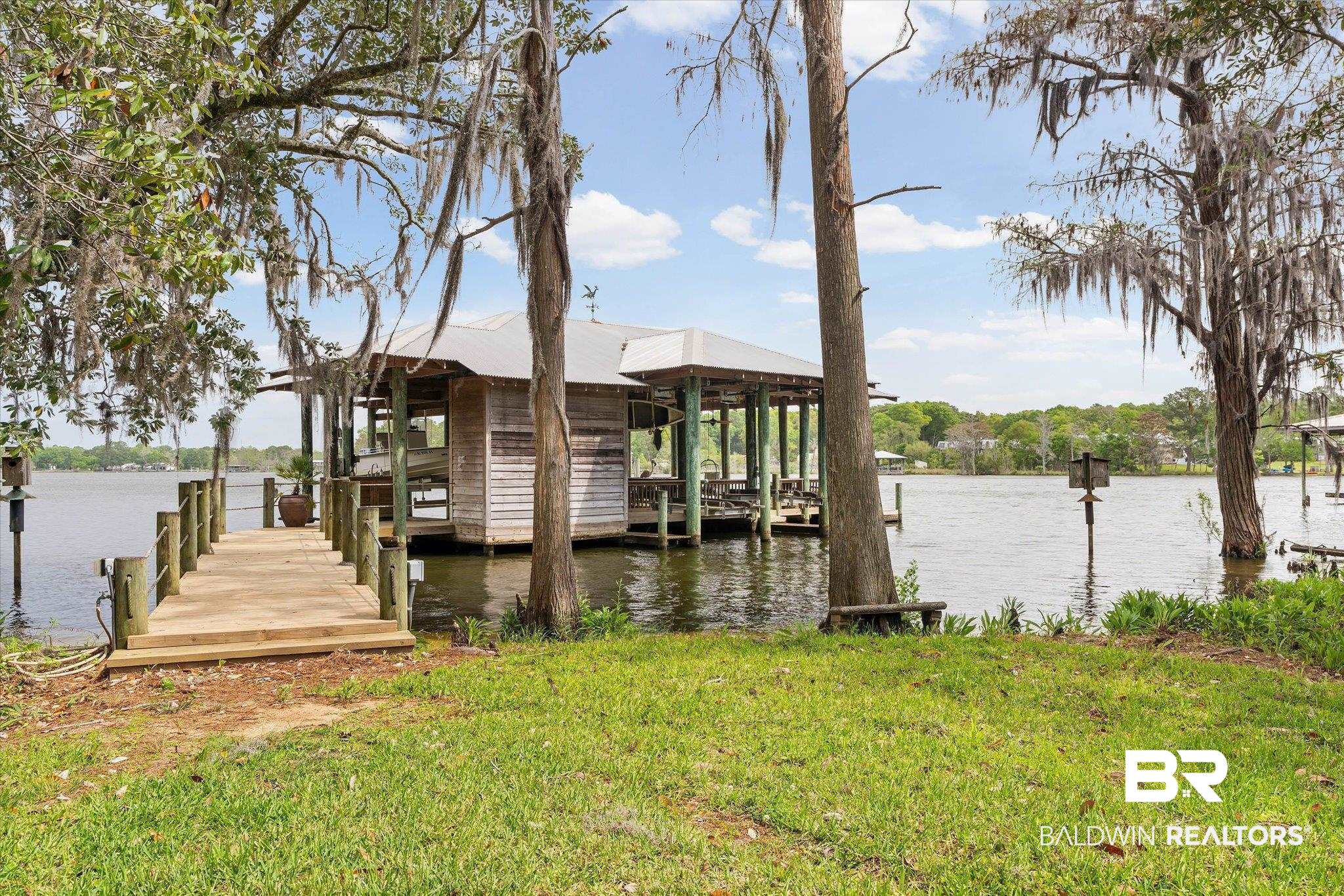 2300 Burgett Road Mobile, AL 36605 - Photo 26 of 40 Dock with a water view, boat lift, and a yard