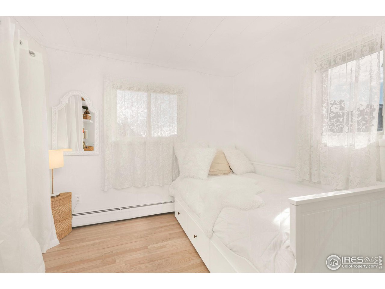11725 Ranch Elsie Road Golden, CO 80403 - Photo 18 of 40 a large white bed in a white room