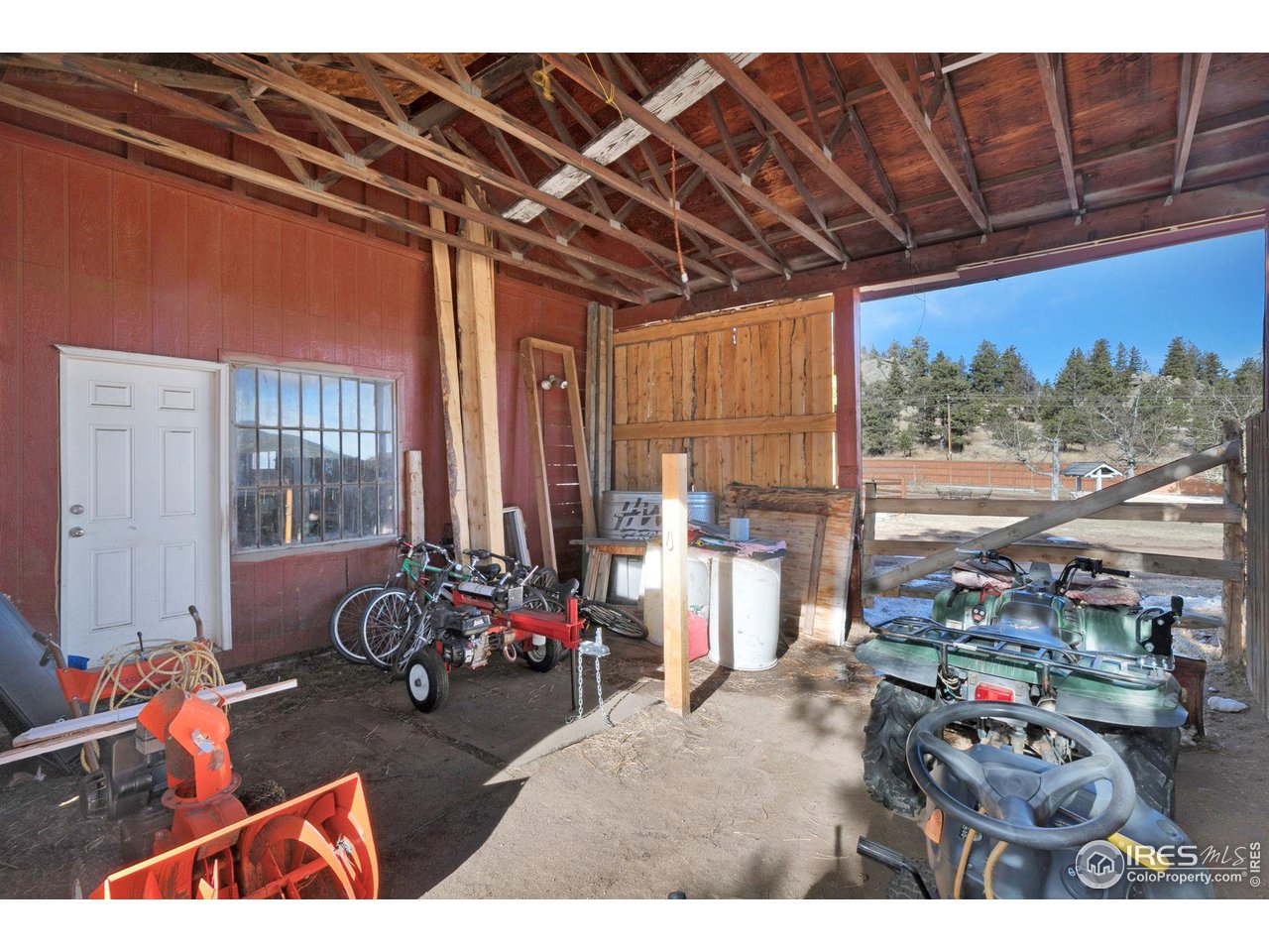 11725 Ranch Elsie Road Golden, CO 80403 - Photo 31 of 40 a garage with furniture and a flat screen tv
