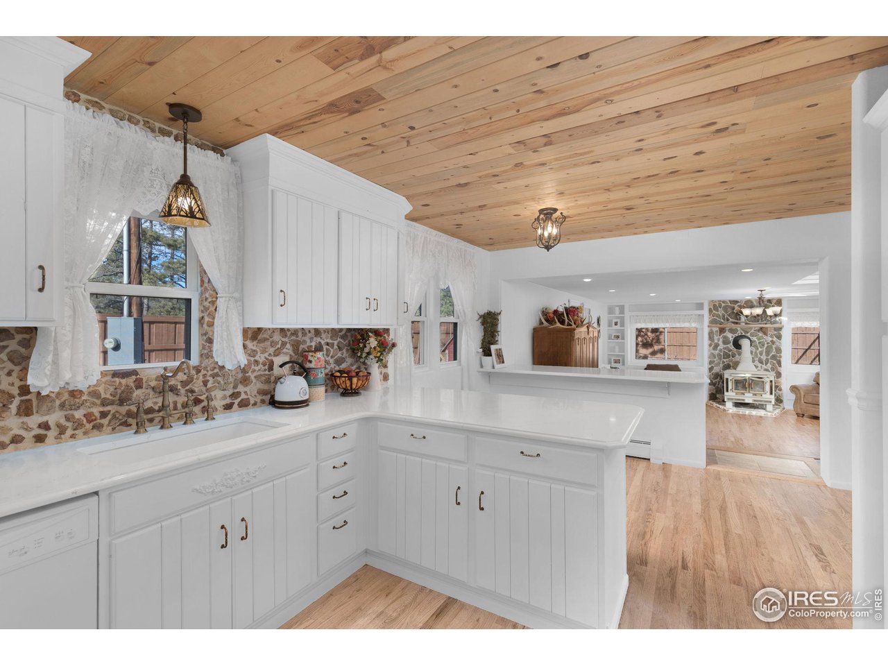 11725 Ranch Elsie Road Golden, CO 80403 - Photo 8 of 40 a kitchen with cabinets and wooden floor