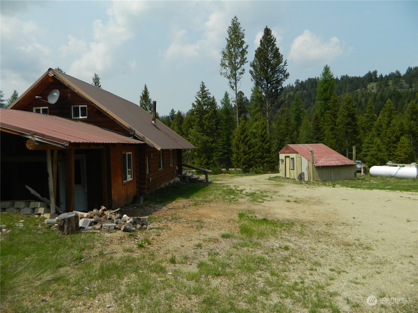 8 Fs 3200 Road Tonasket, WA 98855 - Photo 20 of 34 a front view of house with yard and trees in the background