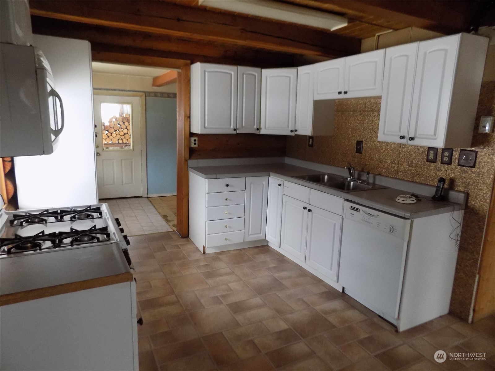 8 Fs 3200 Road Tonasket, WA 98855 - Photo 6 of 34 a kitchen with granite countertop a sink a stove and cabinets