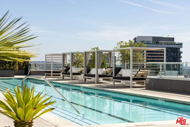 a view of a swimming pool with outdoor seating