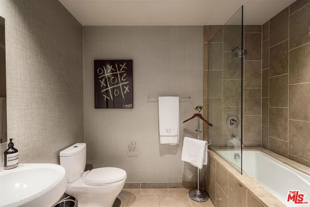 a bathroom with a toilet and a bath tub