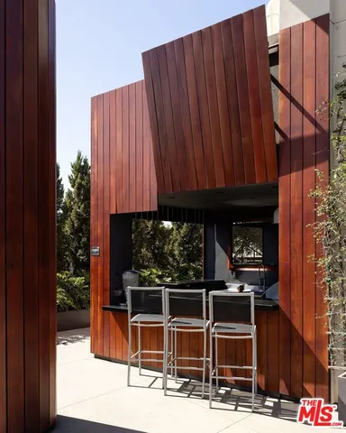a view of a patio with wooden fence