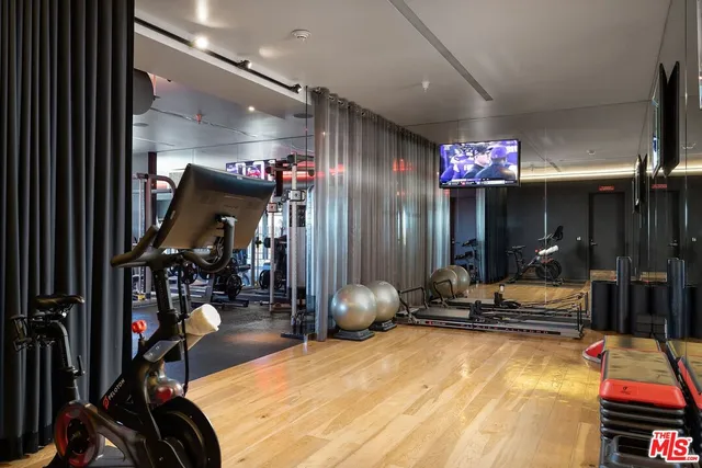 a room with gym equipment and a large window