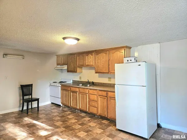 a kitchen with a refrigerator a stove top oven a sink and dishwasher