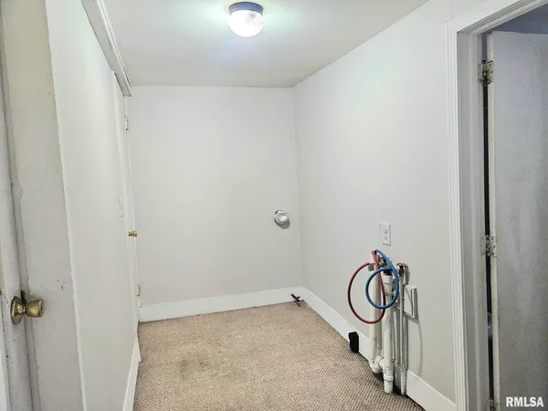 a view of a storage and utility room with a door
