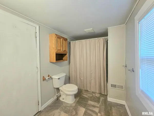 a bathroom with a toilet a sink and shower