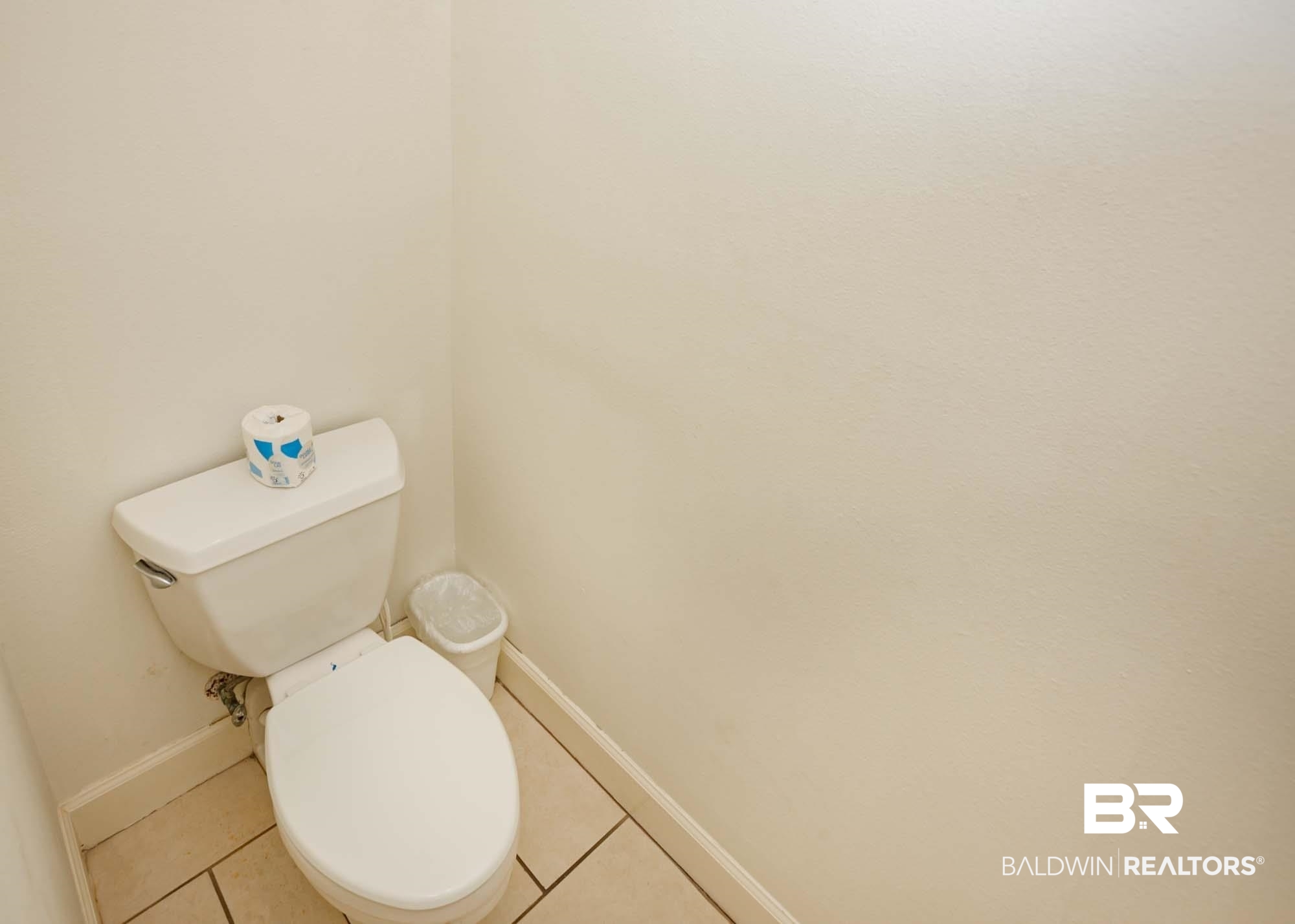 28910 Perdido Beach Boulevard, Unit 4B Orange Beach, AL 36561 - Photo 26 of 48 Bathroom with baseboards, toilet, and tile patterned flooring
