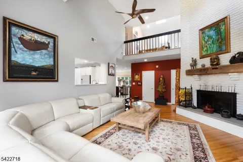 a living room with furniture a fireplace and a rug