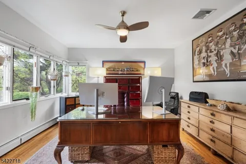 a living room with fireplace furniture and a large window