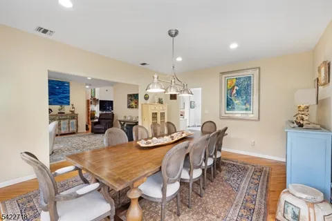 a dining room with furniture a rug and wooden floor