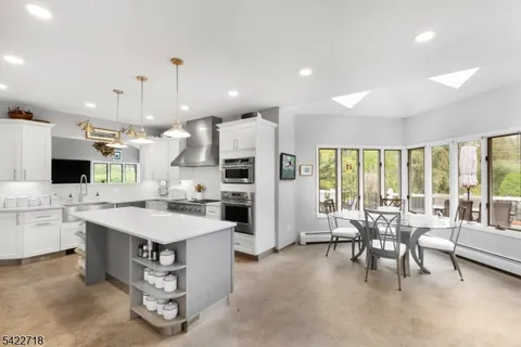 a large kitchen with a table and chairs
