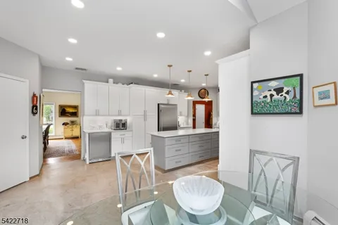 a living room with stainless steel appliances kitchen island furniture and a view of kitchen