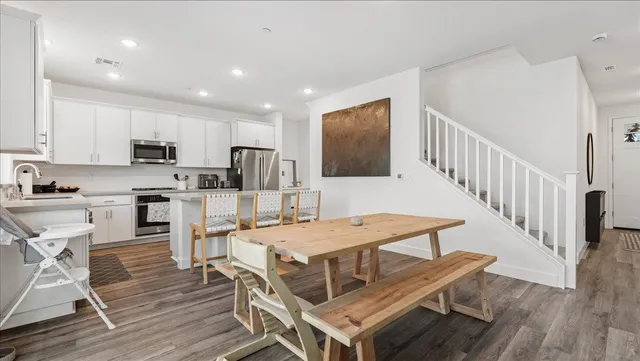 a view of kitchen with cabinets table and chairs