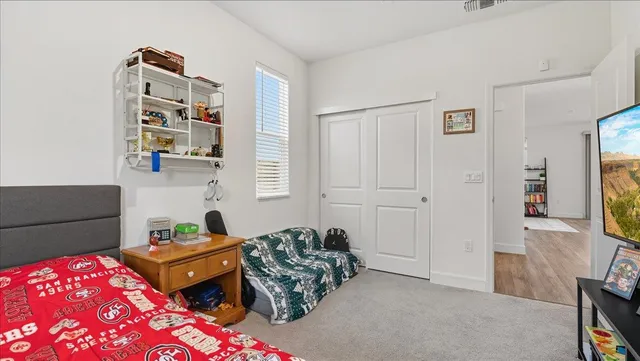 a bedroom with furniture and a flat screen tv