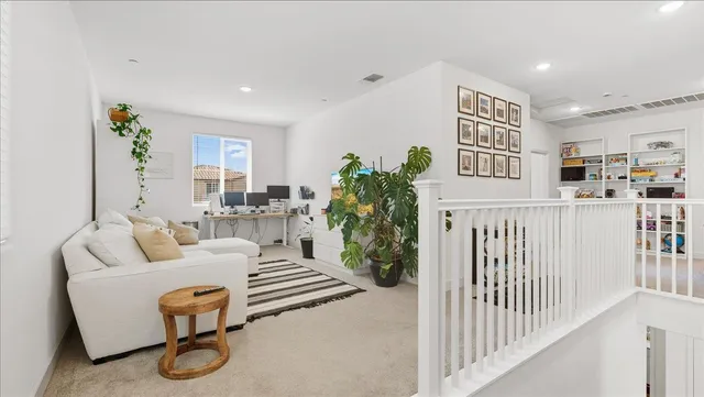 a living room with furniture and white walls