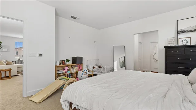 a bedroom with a bed and a dresser