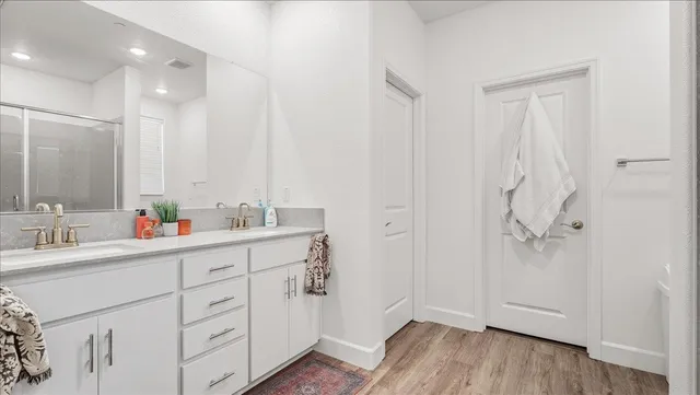 a bathroom with a double vanity sink mirror and