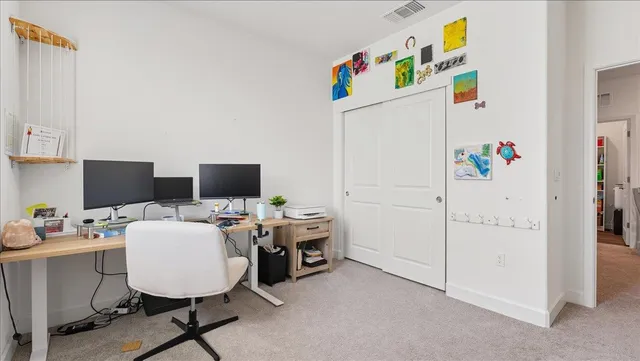 a room with furniture a white cabinet and a refrigerator