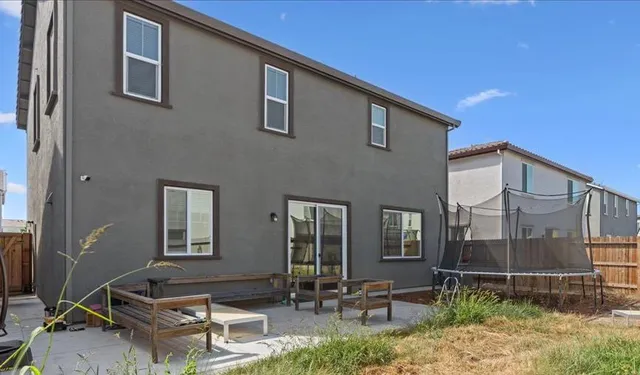 a backyard of a house with yard fire pit and outdoor seating