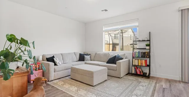a living room with furniture and a book shelf
