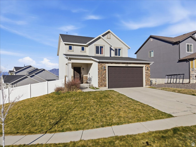 1218 Moonlight Drive Elk Ridge, UT 84651 - Photo 1 of 44 View of front of property featuring concrete driveway, stucco siding, and stone siding