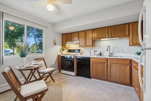 a kitchen with a stove a sink and a refrigerator
