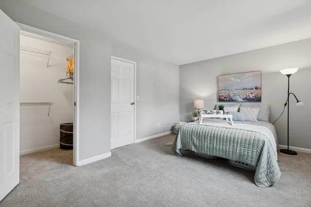 a bedroom with a bed and a painting on the wall