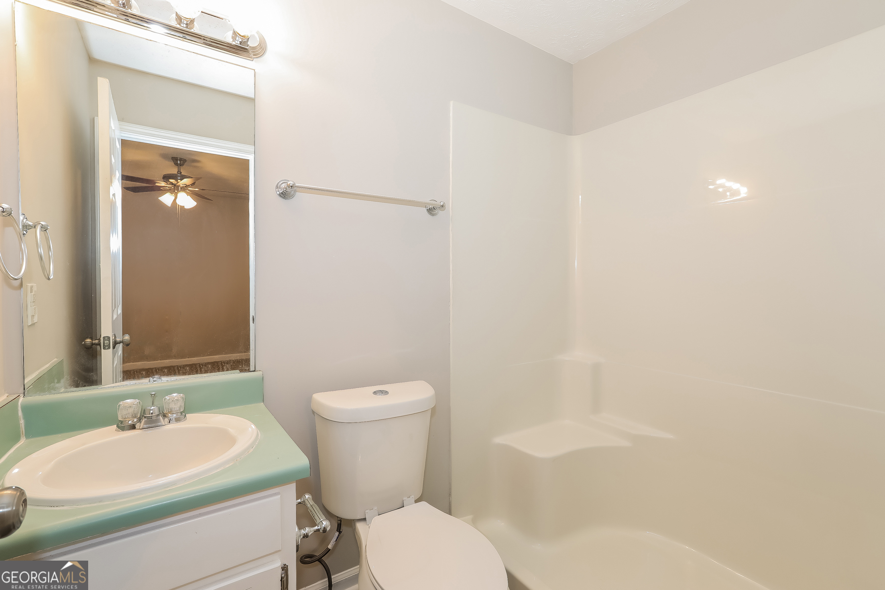 6530 River Hill Drive Flowery Branch, GA 30542 - Photo 13 of 14 a bathroom with a sink toilet and shower