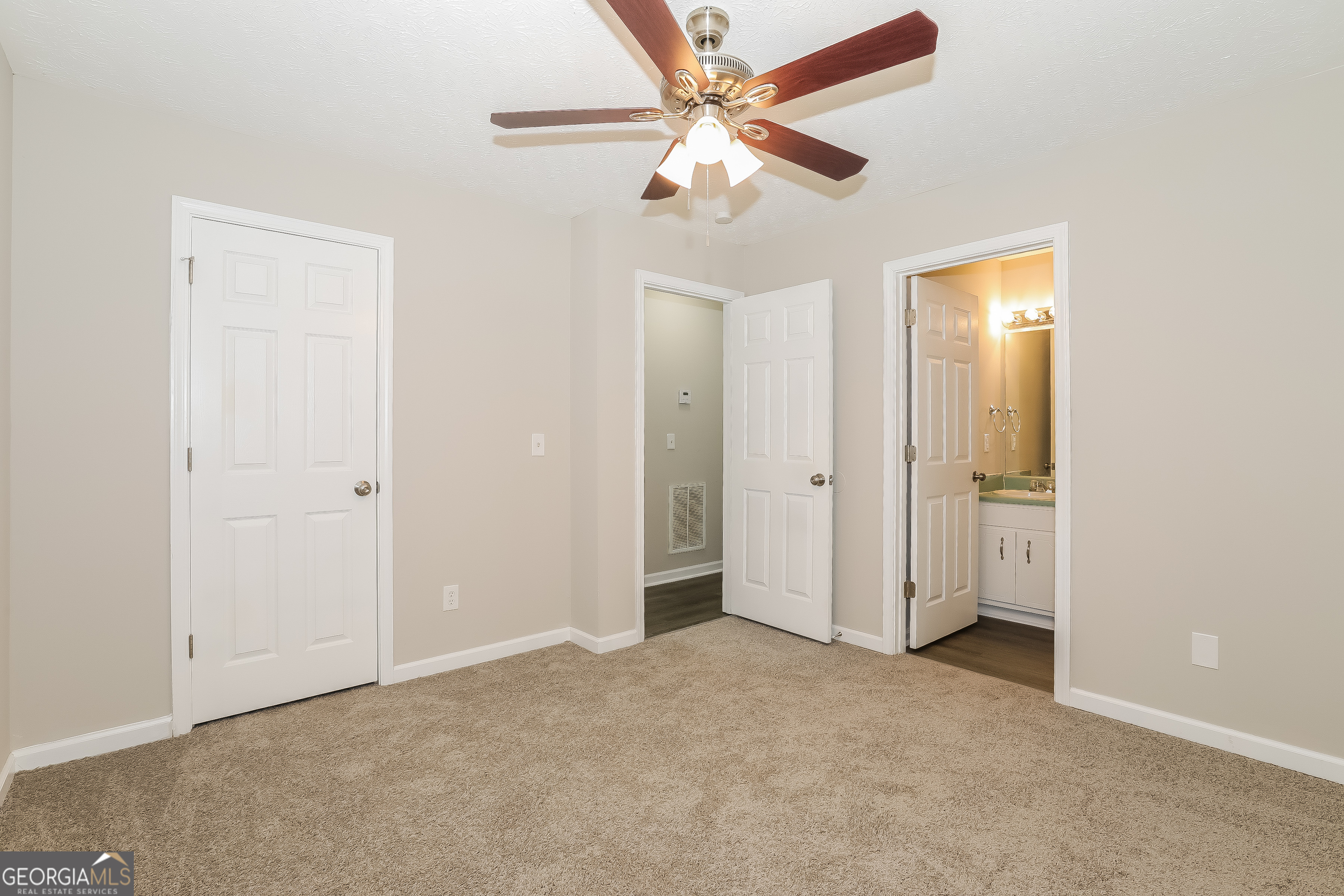 6530 River Hill Drive Flowery Branch, GA 30542 - Photo 7 of 14 an empty room with closet and a ceiling fan