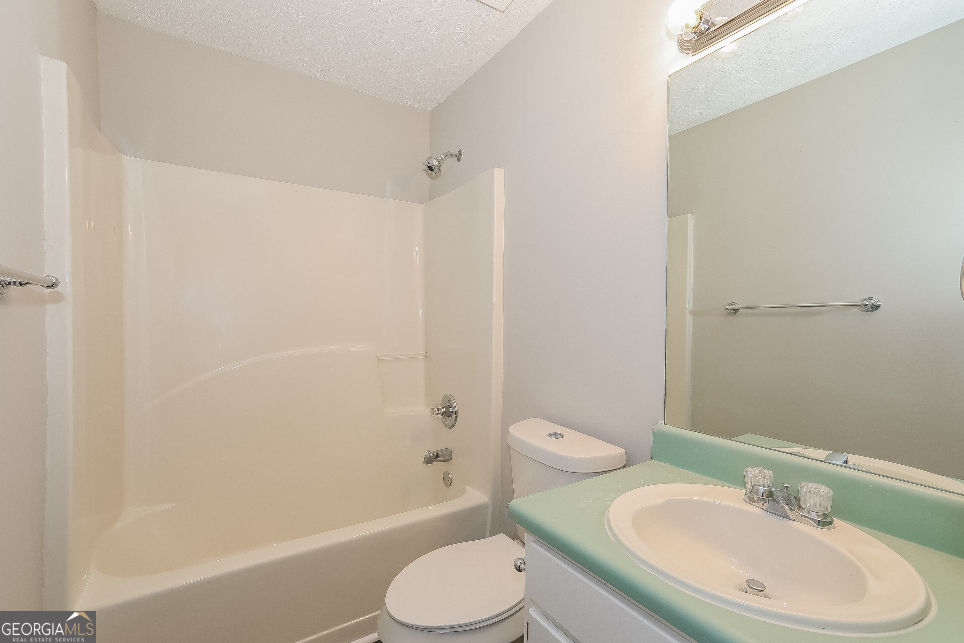 6530 River Hill Drive Flowery Branch, GA 30542 - Photo 8 of 14 a bathroom with a sink toilet and shower