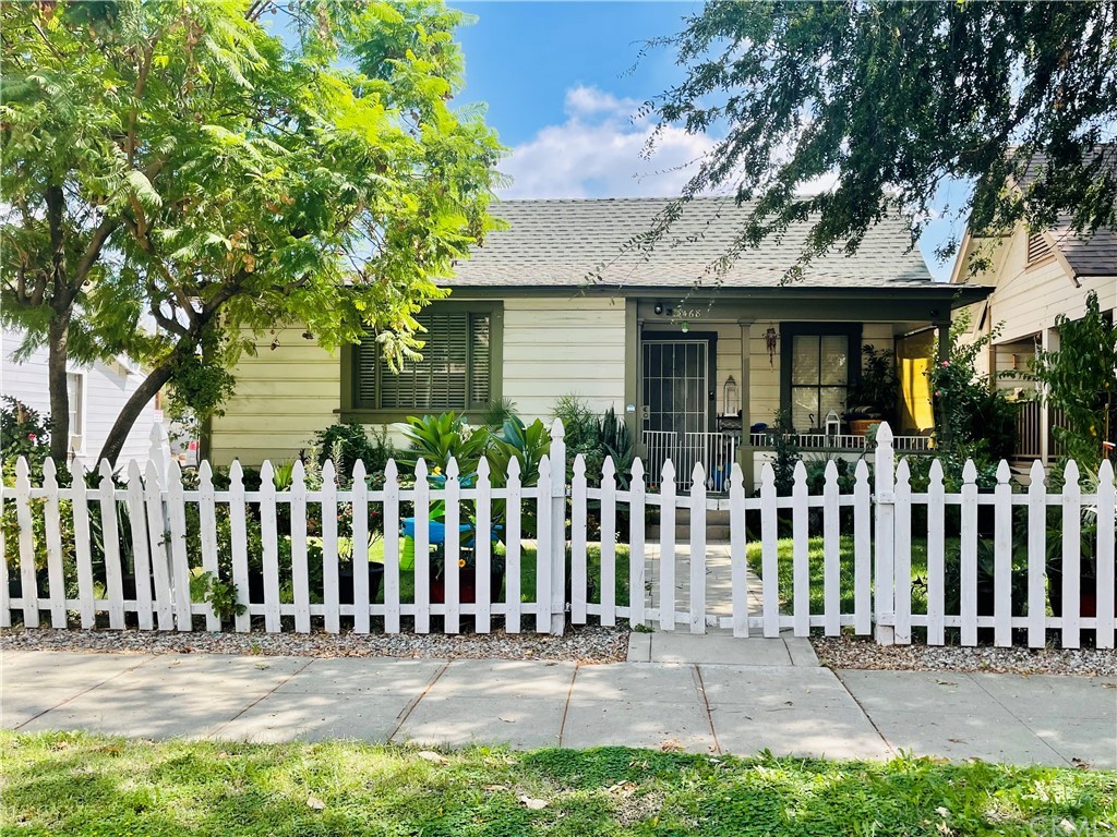 a front view of house with a garden