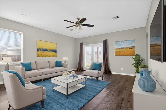 a living room with furniture and a wooden floor