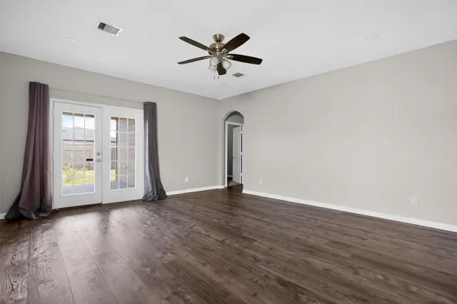 wooden floor in an empty room with a window