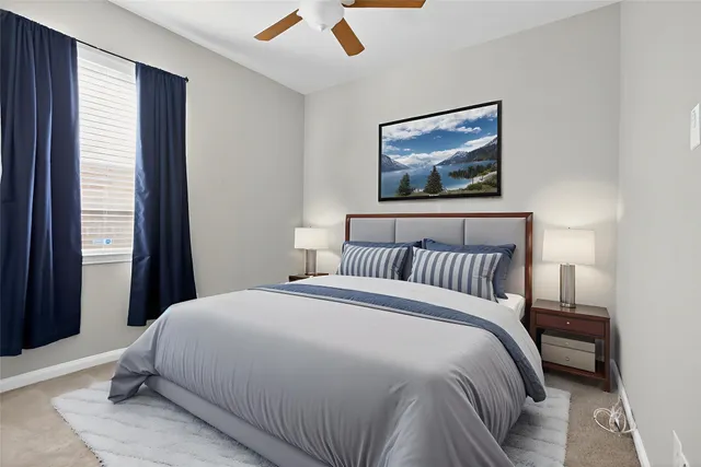 a bedroom with a bed and a painting on the wall