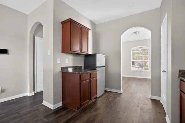 a kitchen with stainless steel appliances granite countertop a refrigerator and a stove top oven