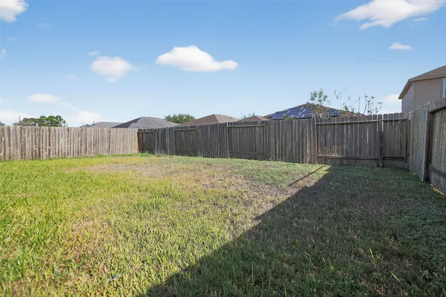a view of a backyard with a fence