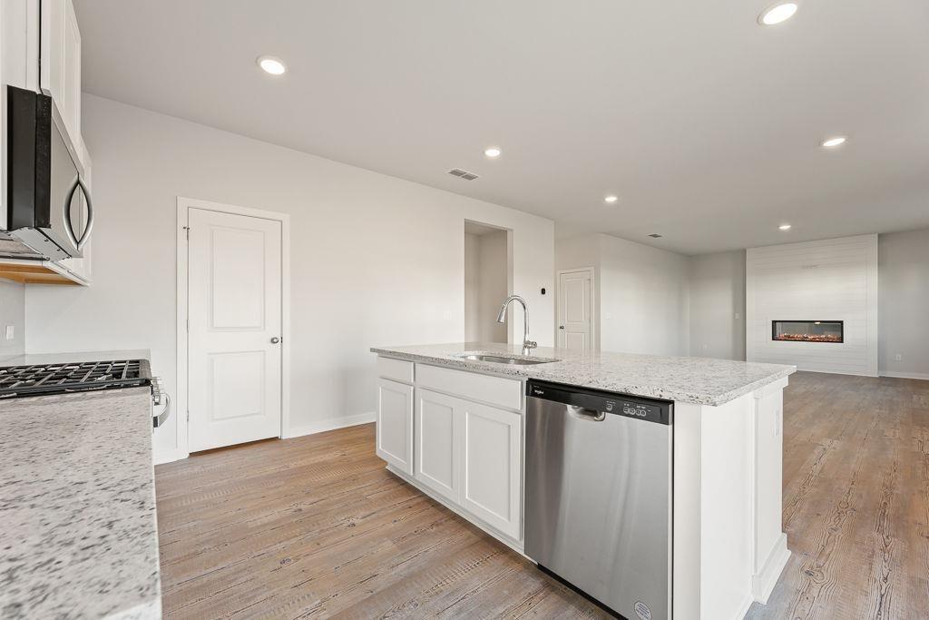 60 Poplar Blf Way Jefferson, GA 30549 - Photo 22 of 28 a kitchen with stainless steel appliances granite countertop a sink and cabinets
