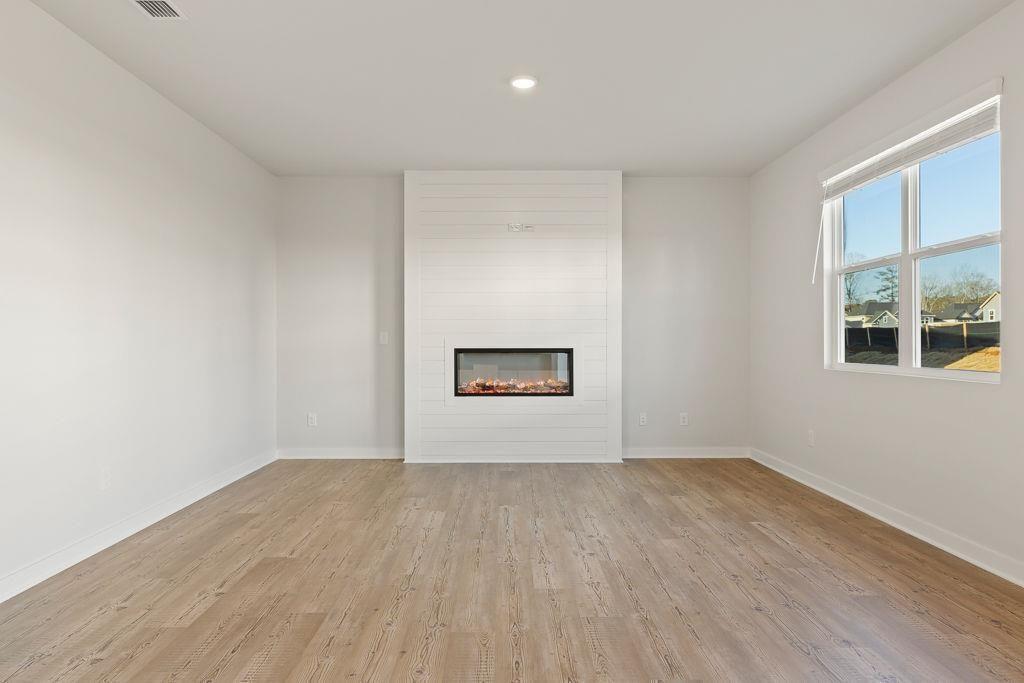 60 Poplar Blf Way Jefferson, GA 30549 - Photo 26 of 28 a view of an empty room with wooden floor and a window