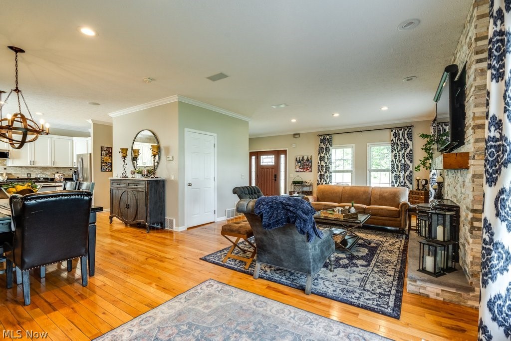 6325 Brecksville Road Independence, OH 44131 - Photo 11 of 50 The property features an open living and dining area with hardwood floors, recessed lighting, and a stone accent wall