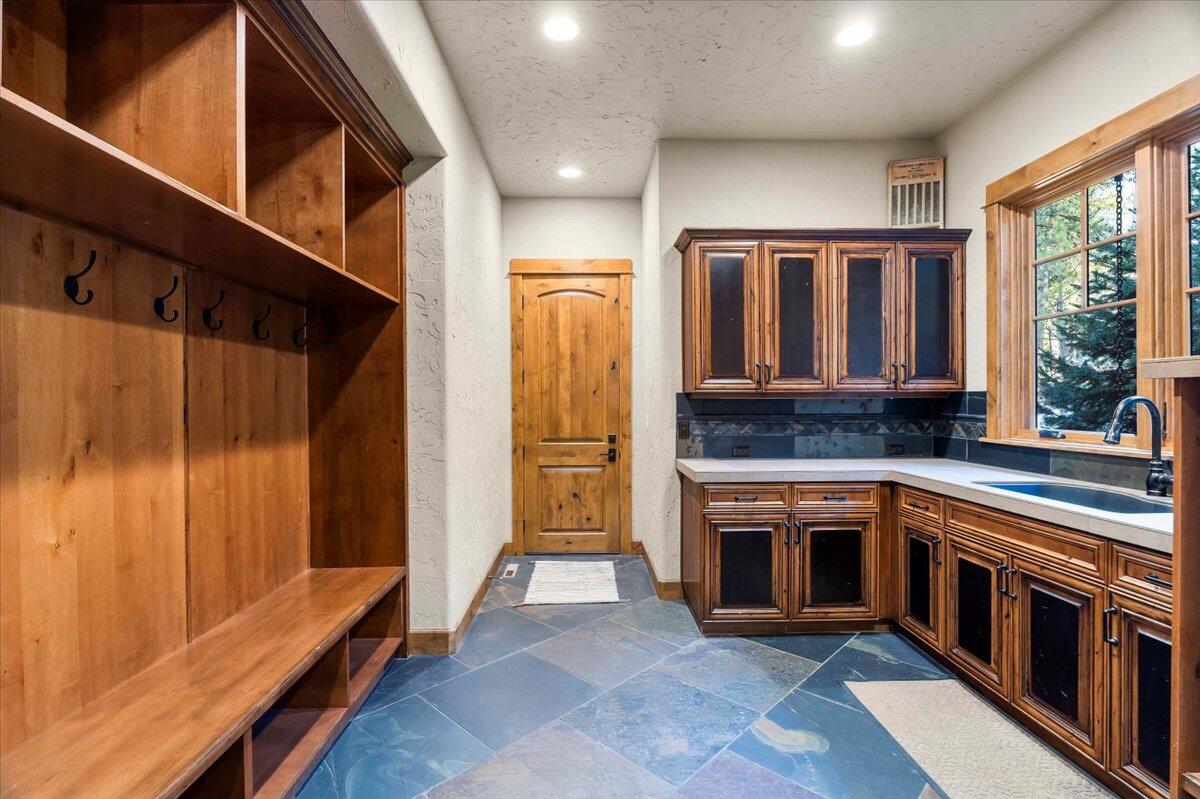 56184 Sable Rock Loop Bend, OR 97707 - Photo 60 of 72 Built in bench and cubbies directly from the garage for all your gear storage