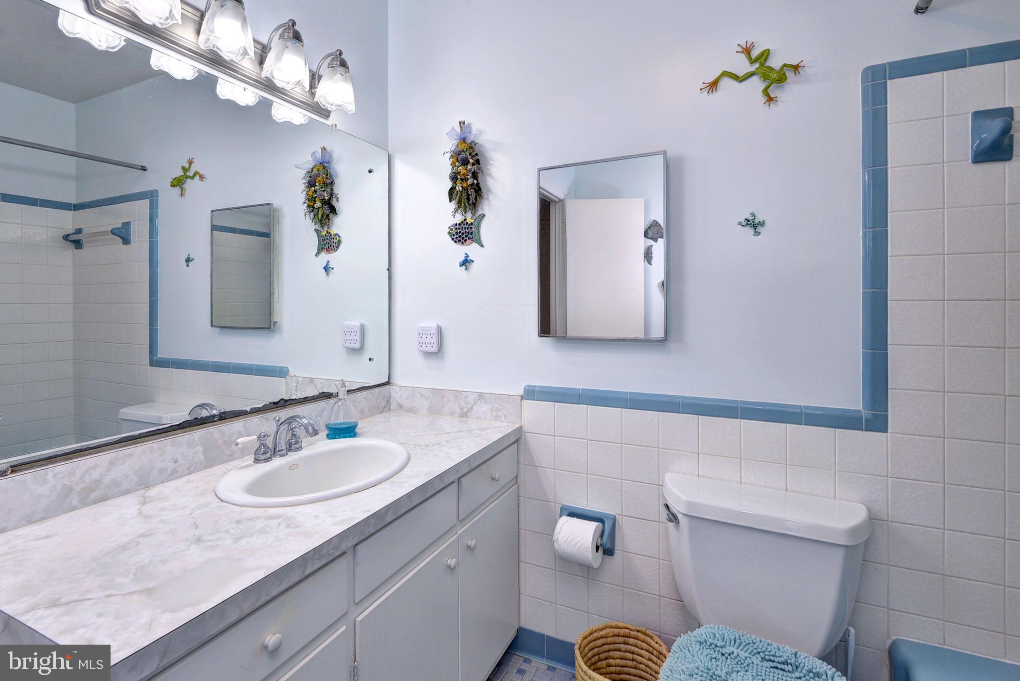 5556 Roanes Wharf Road Gloucester, VA 23061 - Photo 17 of 84 a bathroom with a granite countertop sink a toilet a mirror and shower