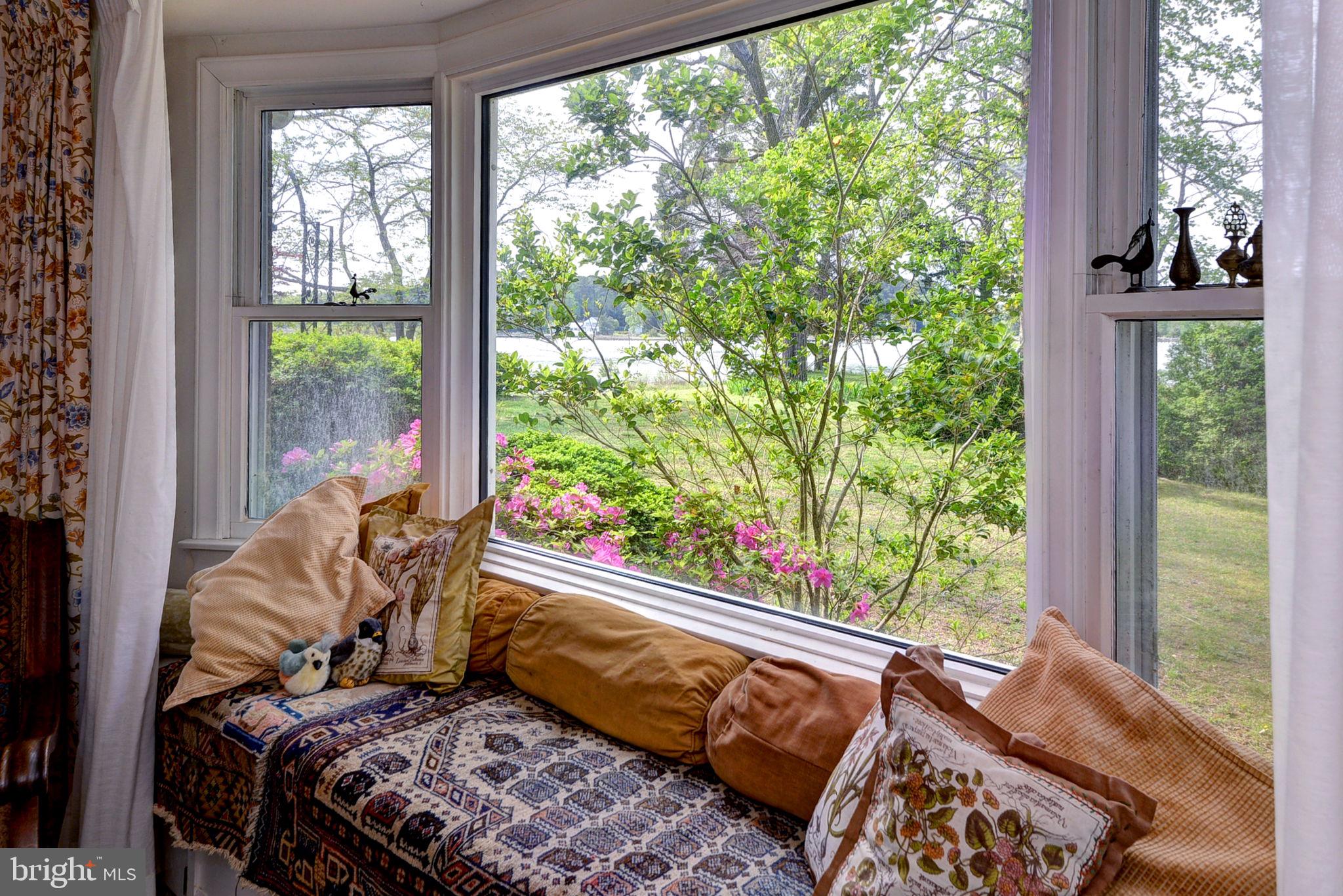 5556 Roanes Wharf Road Gloucester, VA 23061 - Photo 19 of 84 a bed sitting in a bedroom next to a window